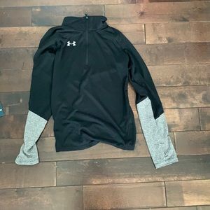 a grey and back under armour zip up